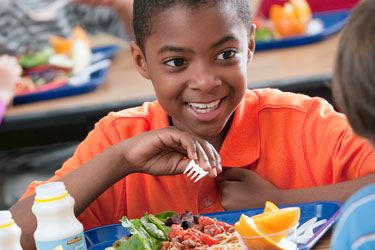 Photo of student eating lunch as part of National School Lunch Program